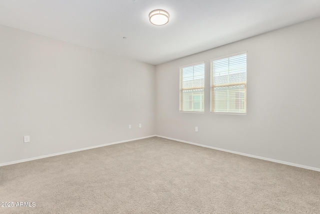 empty room with carpet and baseboards