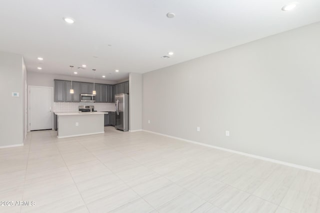 unfurnished living room with recessed lighting, light tile patterned flooring, and baseboards