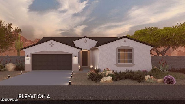 mediterranean / spanish house featuring stucco siding, concrete driveway, an attached garage, and fence