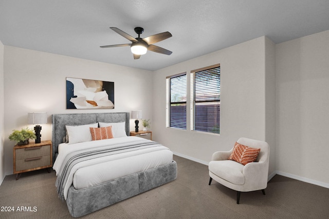 bedroom with ceiling fan and dark carpet