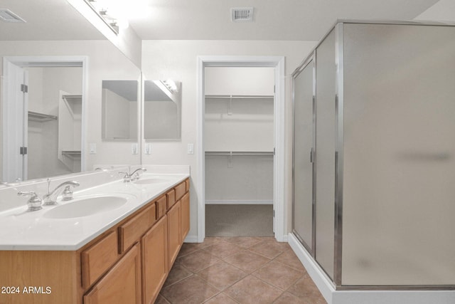 bathroom featuring vanity, an enclosed shower, and tile patterned floors