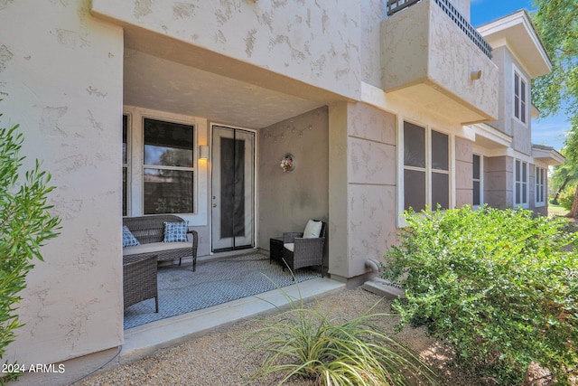 view of exterior entry featuring a patio area