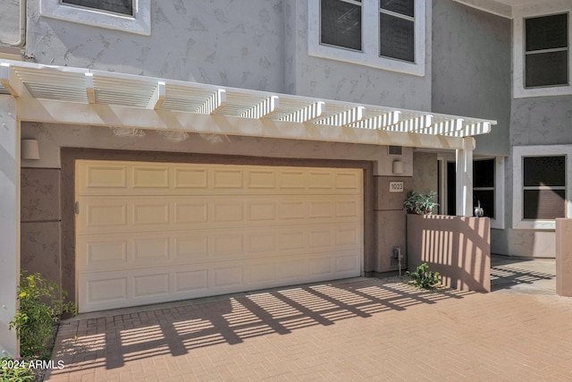 view of front facade featuring a pergola and a garage