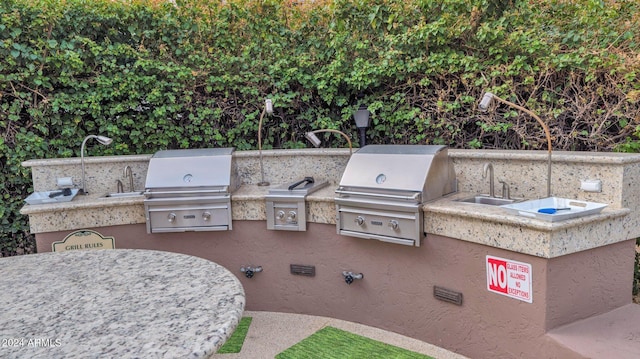 view of patio featuring grilling area, sink, and exterior kitchen