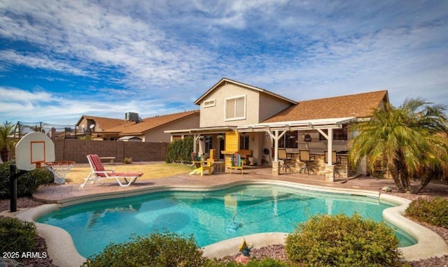 view of pool featuring a patio area and an outdoor bar