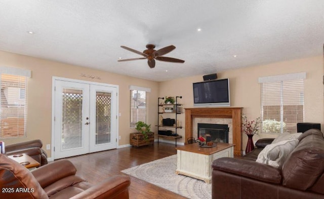 living room with a textured ceiling, french doors, ceiling fan, and dark hardwood / wood-style floors