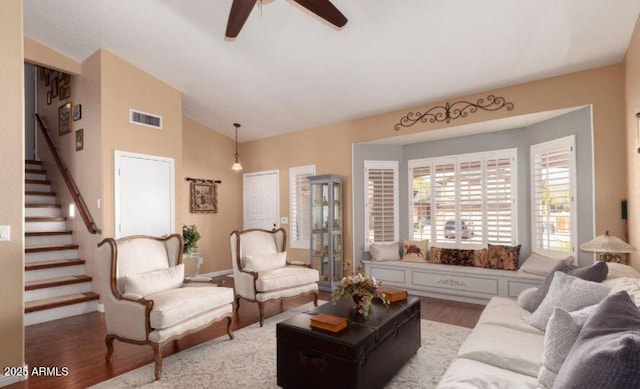 living room with ceiling fan, lofted ceiling, and wood-type flooring