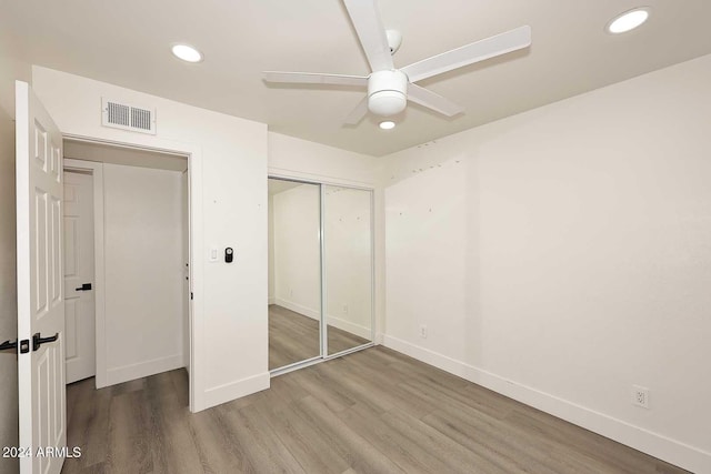 unfurnished bedroom featuring baseboards, visible vents, recessed lighting, and wood finished floors