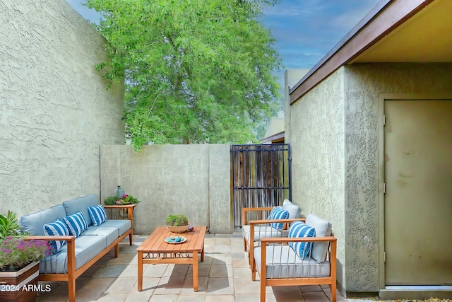view of patio featuring outdoor lounge area and fence