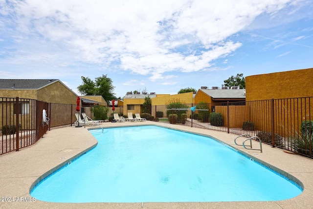 pool featuring fence and a patio area