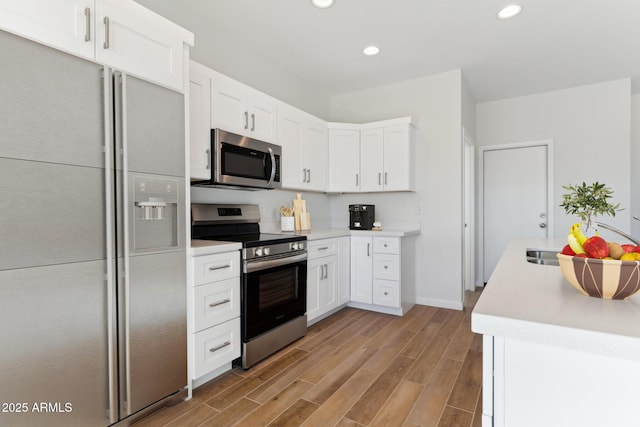 11263 E Crescent Ave, Mesa, AZ 85208 - kitchen with appliances with stainless steel finishes, recessed lighting, light countertops, white cabinets, and light wood-style floors