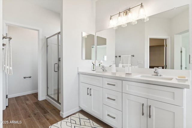11263 E Crescent Ave, Mesa, AZ 85208 - full bathroom with a shower stall, wood finished floors, double vanity, and baseboards