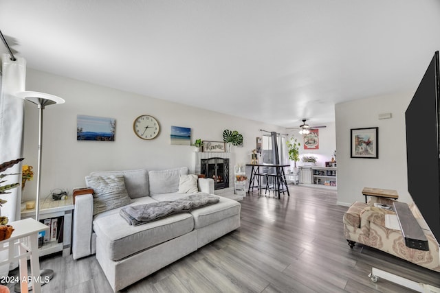 living room featuring ceiling fan and hardwood / wood-style flooring