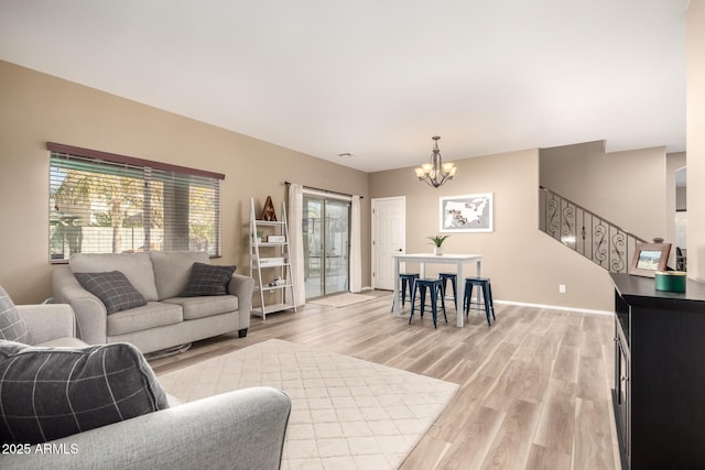 living room featuring an inviting chandelier and light hardwood / wood-style floors