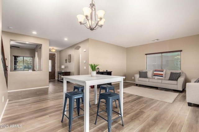 dining area with a notable chandelier and hardwood / wood-style flooring