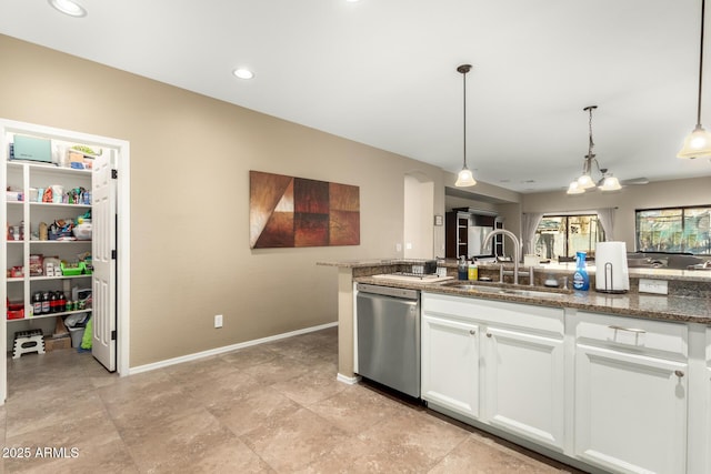 kitchen featuring sink, pendant lighting, white cabinets, and dishwasher