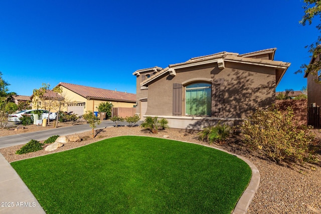 mediterranean / spanish-style house featuring a front lawn and a garage