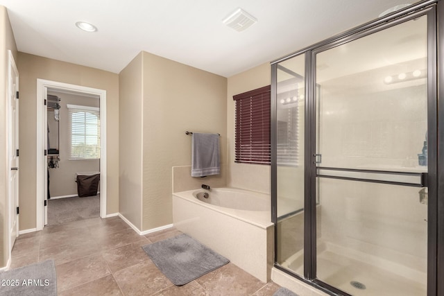 bathroom featuring shower with separate bathtub