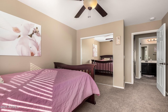 bedroom featuring ensuite bathroom, a closet, carpet, and ceiling fan