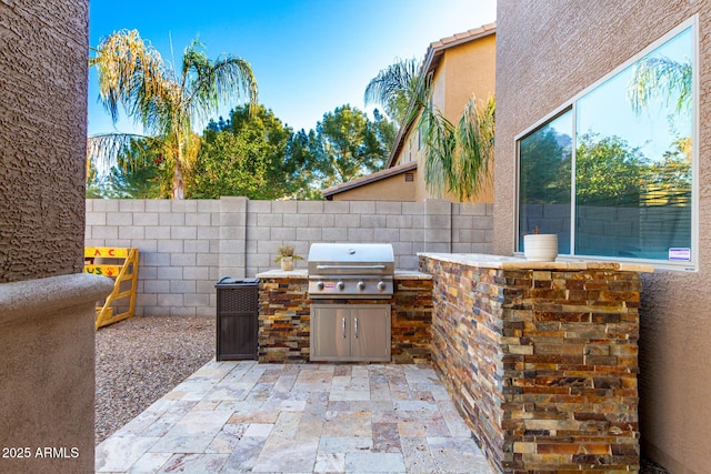 view of patio / terrace featuring an outdoor kitchen and area for grilling