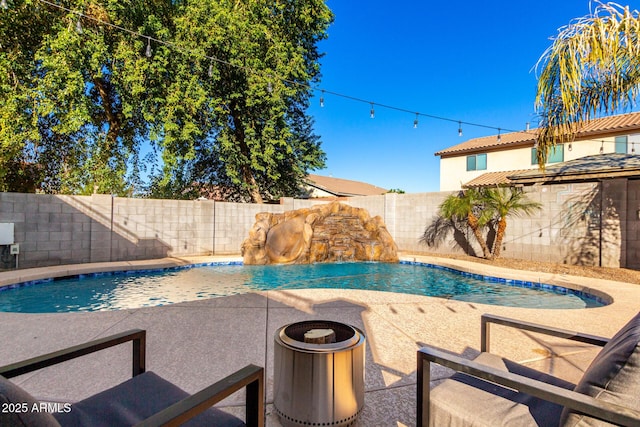 view of swimming pool with pool water feature