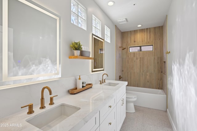 full bathroom featuring vanity, toilet, and tiled shower / bath combo