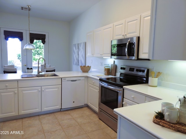 kitchen featuring visible vents, white cabinetry, stainless steel appliances, and a sink