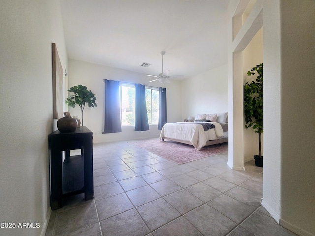 tiled bedroom featuring baseboards, a ceiling fan, and visible vents