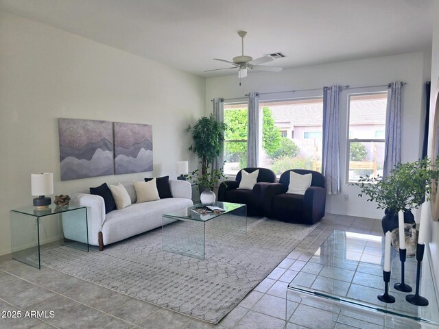 living area featuring ceiling fan and visible vents