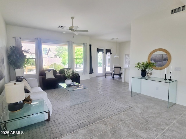 tiled living room with a ceiling fan and visible vents