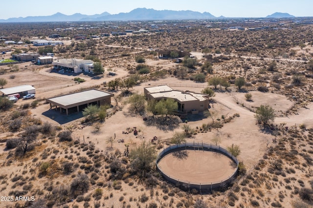 birds eye view of property featuring view of desert and a mountain view