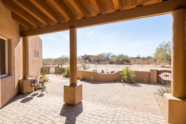 view of patio featuring a gate and fence