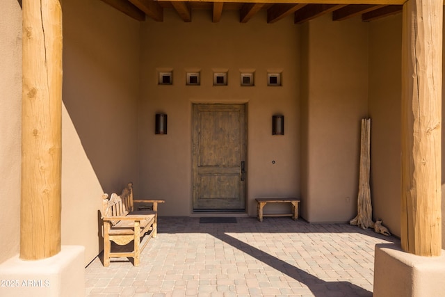 property entrance with stucco siding