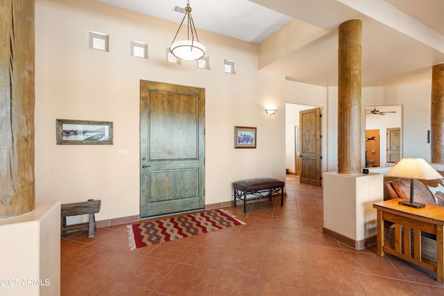 entrance foyer featuring visible vents, baseboards, decorative columns, and tile patterned floors