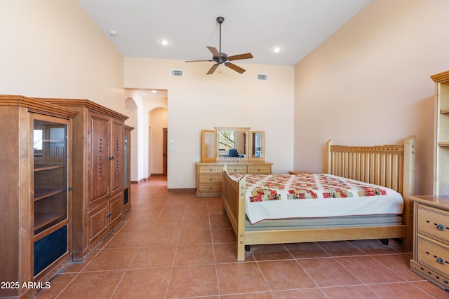 bedroom featuring arched walkways, recessed lighting, visible vents, and tile patterned floors