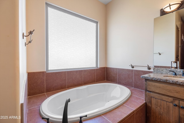 bathroom with vanity and a bath