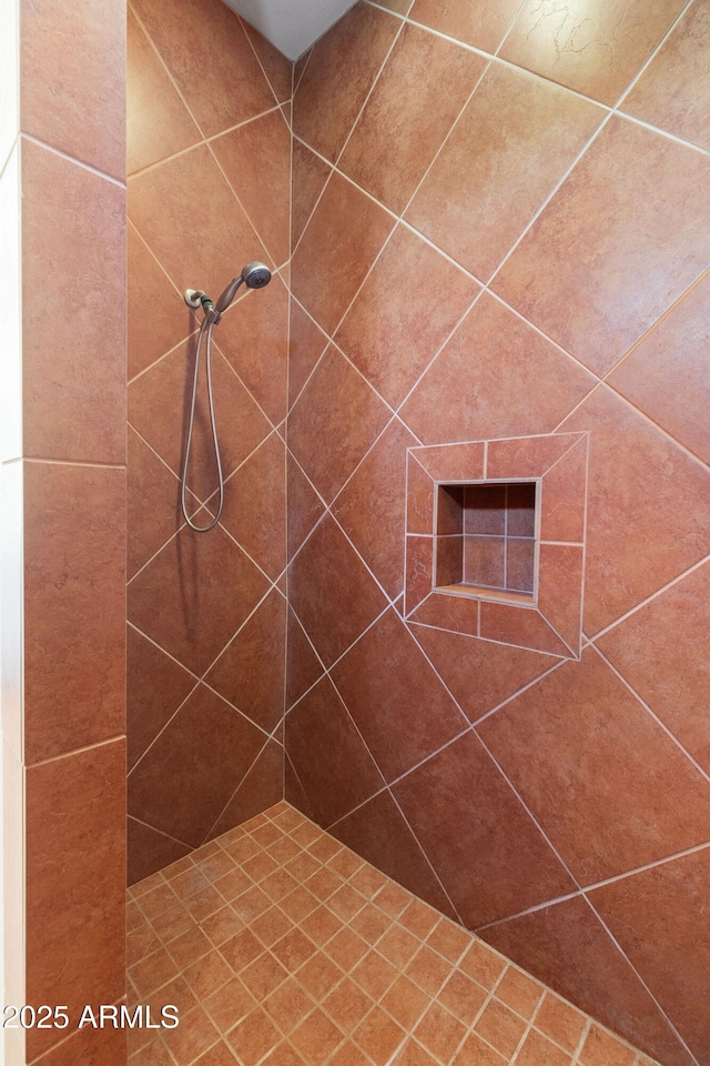 bathroom with tiled shower