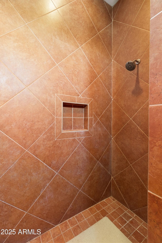 bathroom with tiled shower