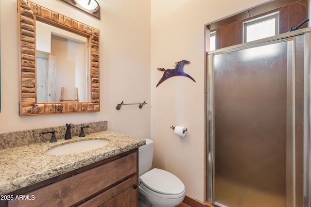 full bath with a shower stall, toilet, and vanity