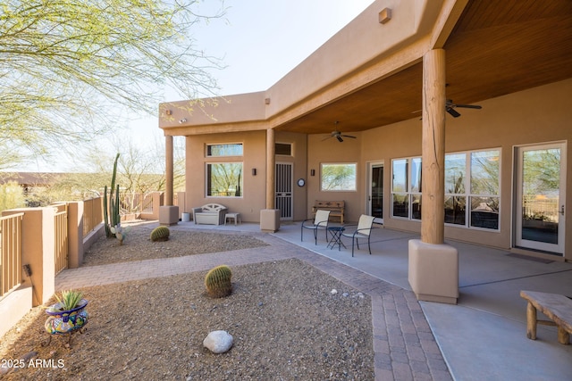 view of patio with fence and a ceiling fan