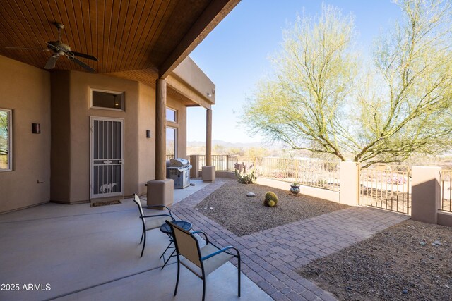 view of patio featuring ceiling fan, fence, and grilling area