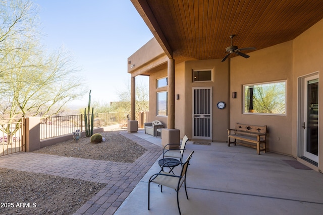 view of patio / terrace featuring a ceiling fan and fence