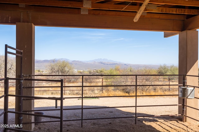 view of yard featuring an outdoor structure, an exterior structure, and a mountain view