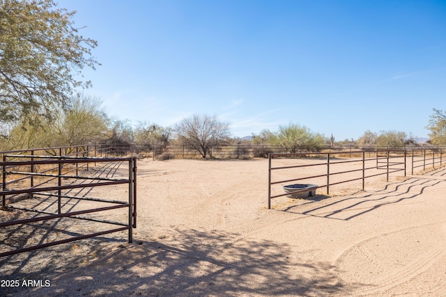 view of yard with an outdoor structure, an exterior structure, and a rural view