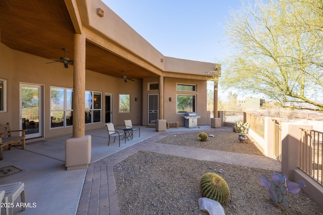 view of patio with a ceiling fan, a grill, and fence