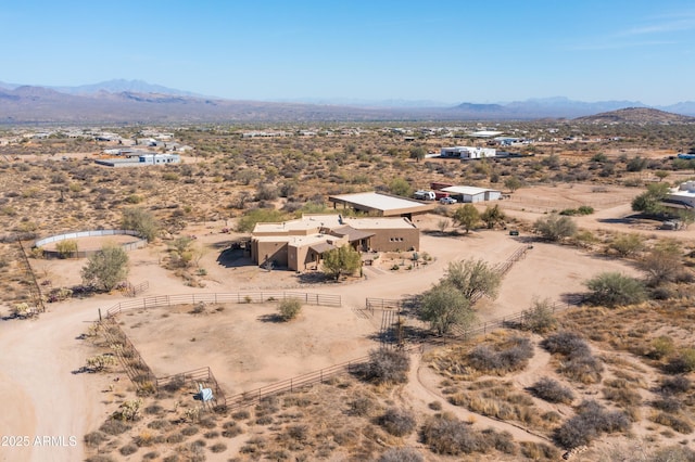 drone / aerial view featuring view of desert, a rural view, and a mountain view