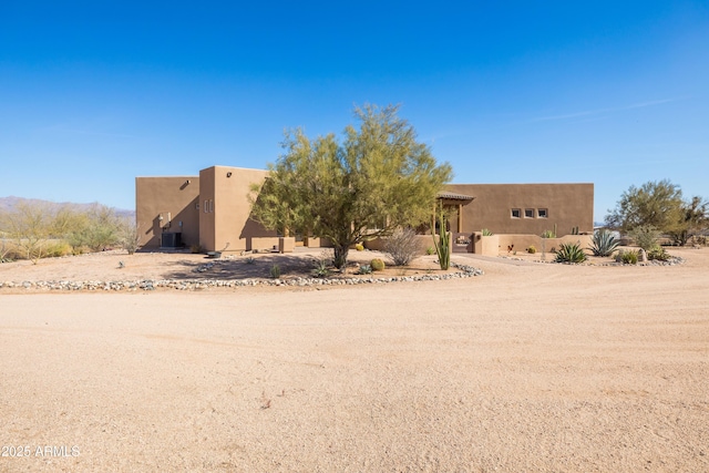 view of front of house featuring cooling unit and stucco siding