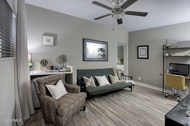 living room with ceiling fan and light hardwood / wood-style flooring