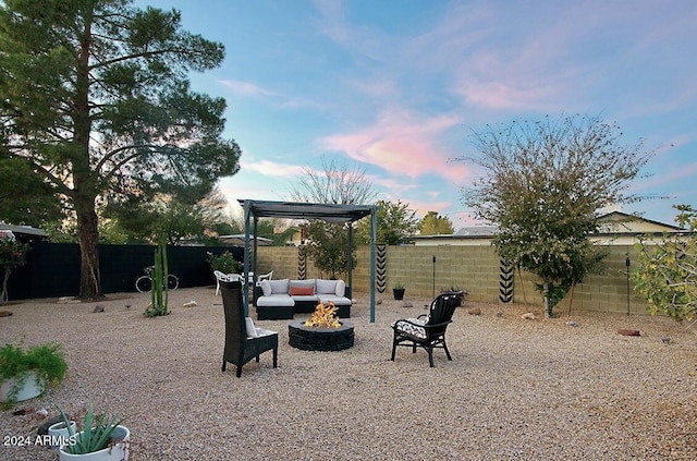 yard at dusk with an outdoor living space with a fire pit