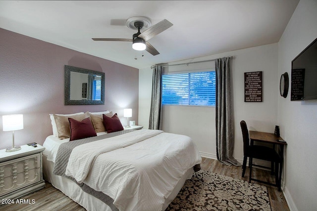 bedroom with ceiling fan and light hardwood / wood-style flooring